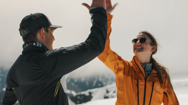 Two happy people doing high five