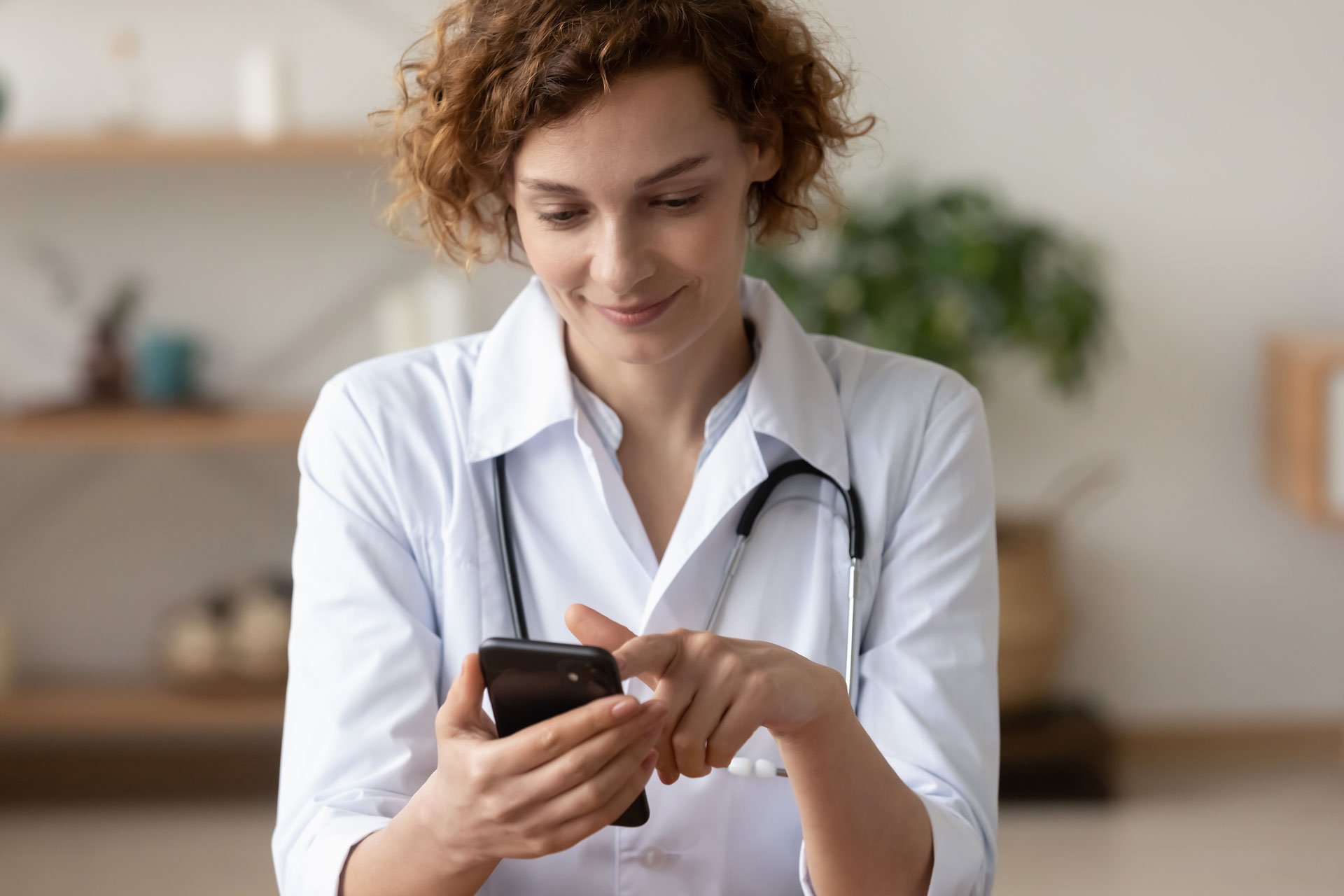 hcp-female-holding-phone--shutterstock-1720779982