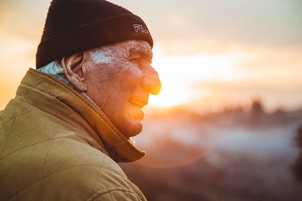Older man with a black cap in the sunset